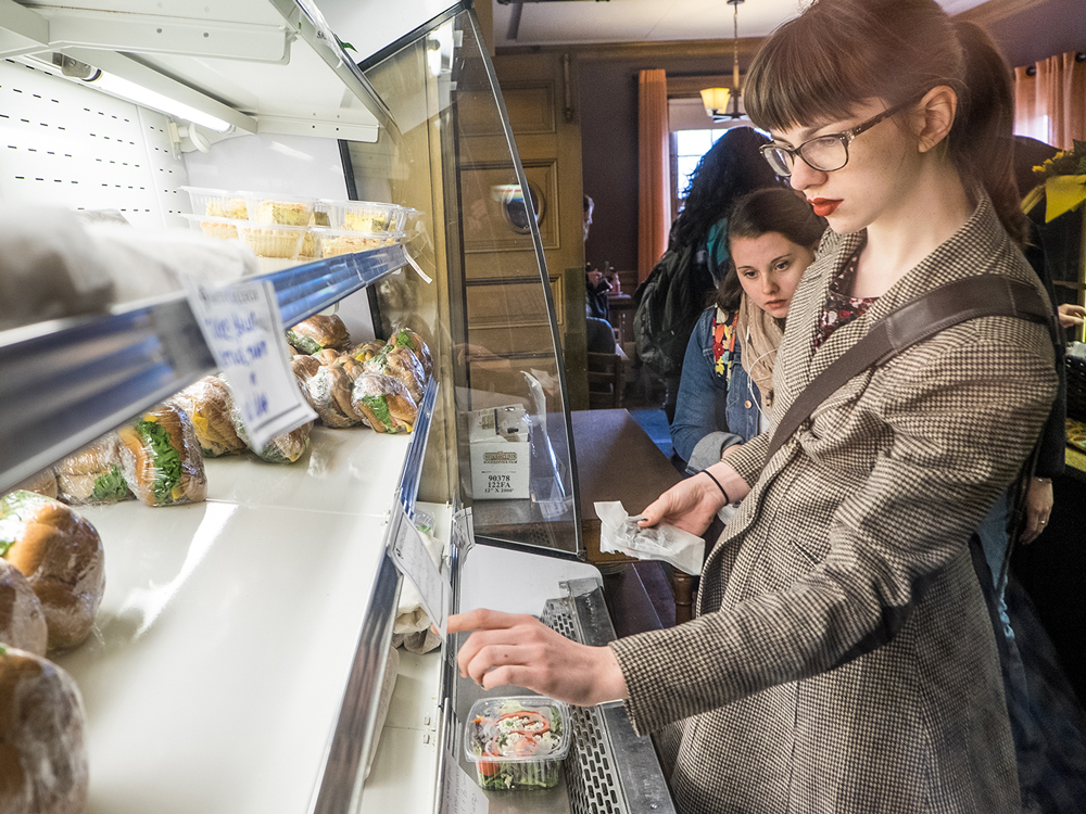 Students choosing food from a grab and go cold case