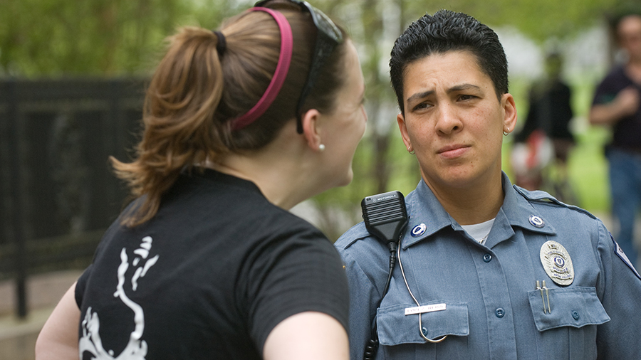 Campus police officer talking to a student