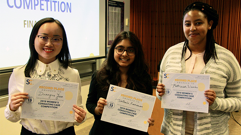 Group of students smiling and displaying certificates