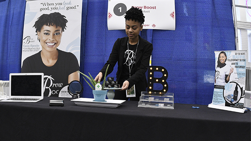 A participant at her product demonstration stand