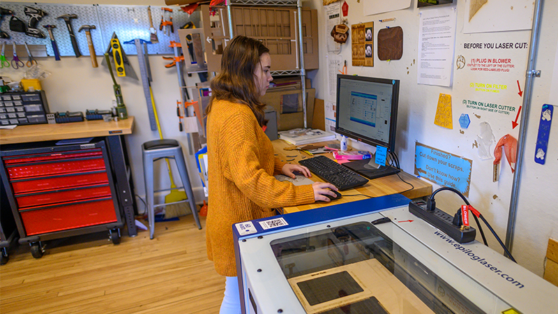 Smith student using the lasercutter