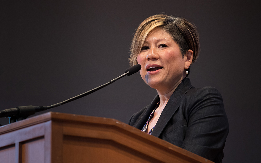 Marianne Yoshioka speaking at a podium