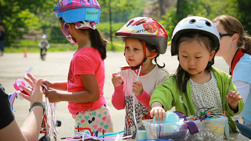 Three girls in bike helmets