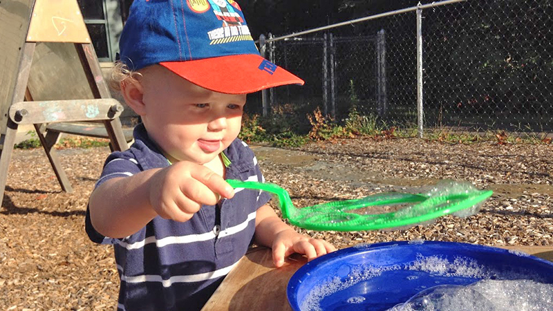 Young child making bubbles