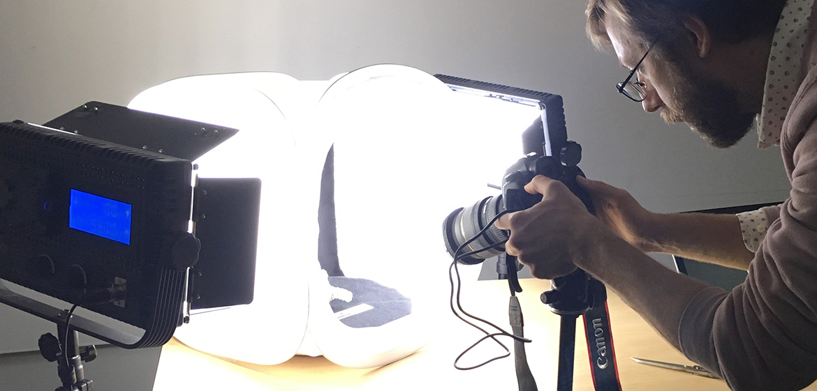 Andrew Maurer photographing a fossilized shrimp burrow 