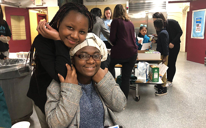 Two young students at a community service event