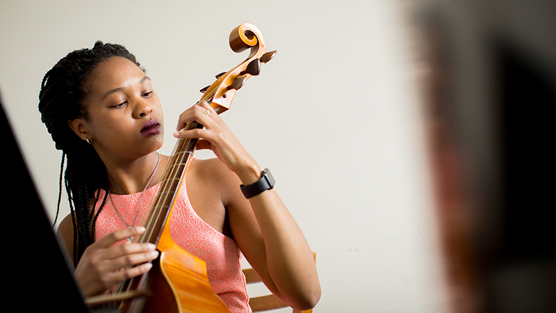 Hannah Simmons tunes a viola