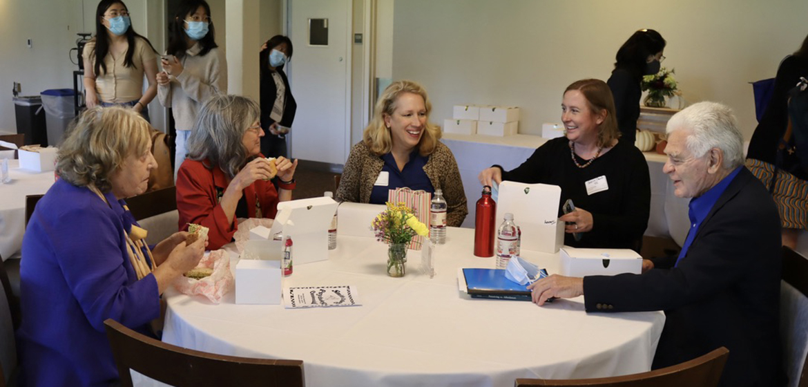 Faculty members and alums eating lunch in the conference center.