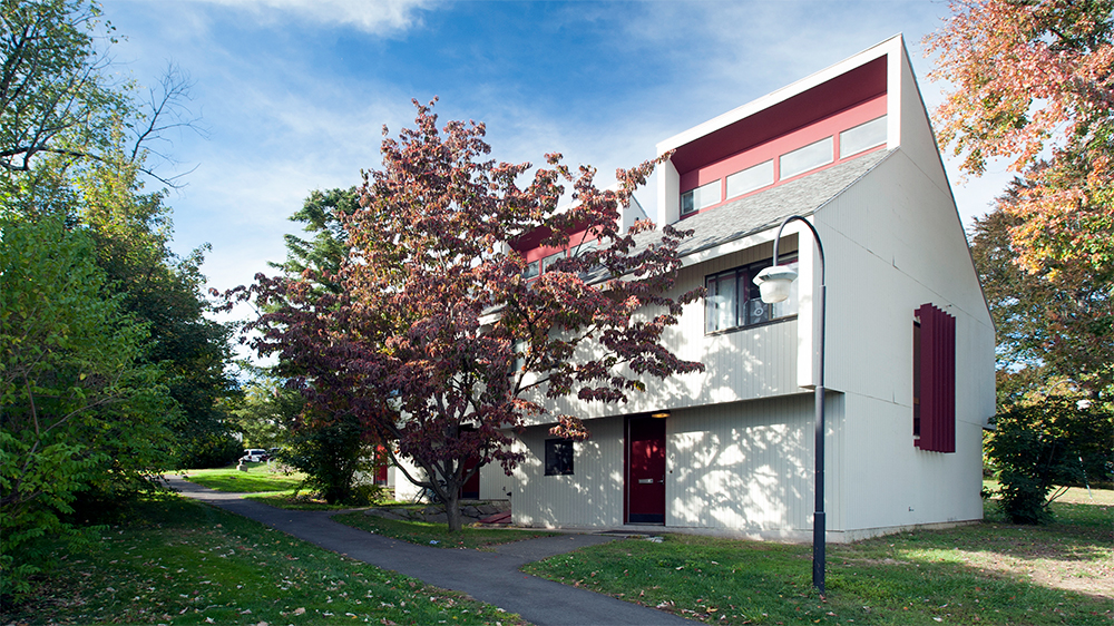 Exterior of the Henshaw A apartment building, white siding with red trim