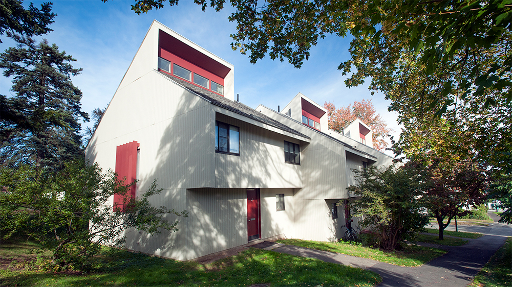 Exterior of the Henshaw A apartment building, white siding with red trim