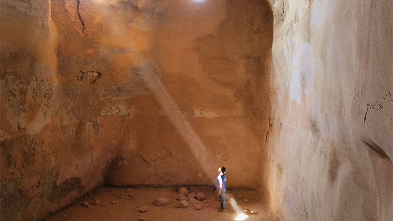 Photo of a student standing in a ray of sunlight in Israel