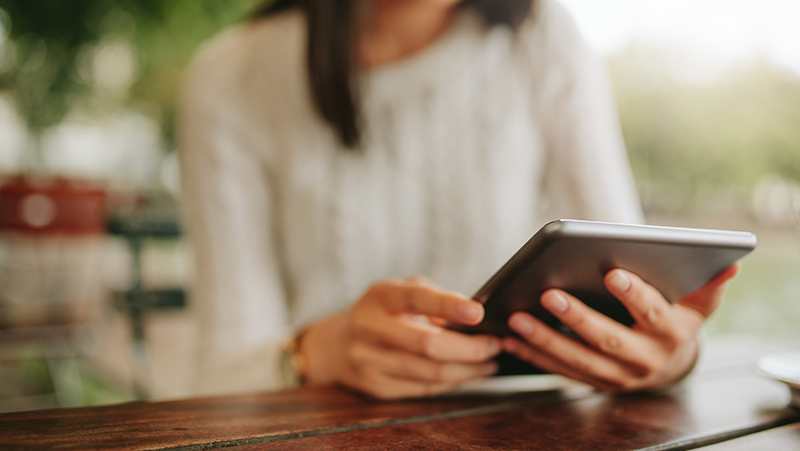 Closeup of woman's hands holding a tablet