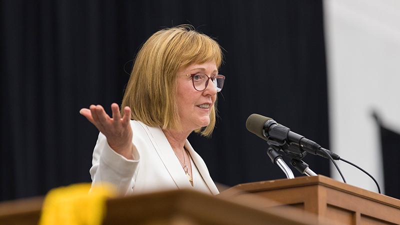 President Kathy McCartney at the podium