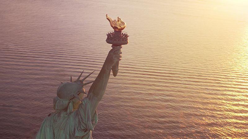 View of the Statue of Liberty's torch from behind, looking out to sea