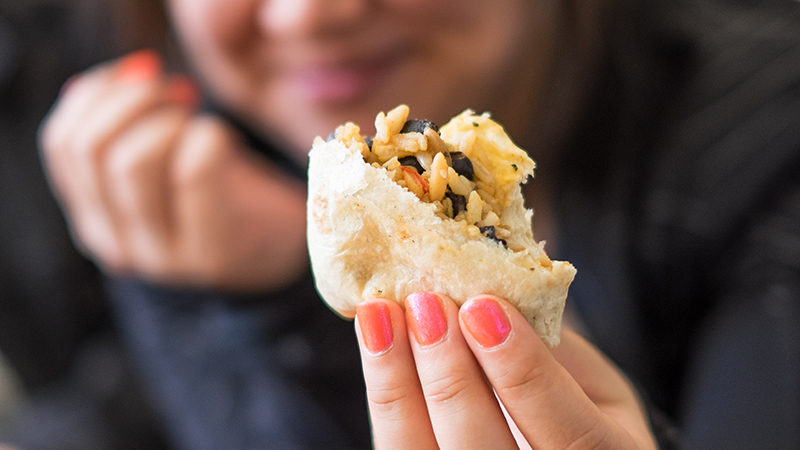 Close-up of a student holding food in Cutter-Ziskind dining room