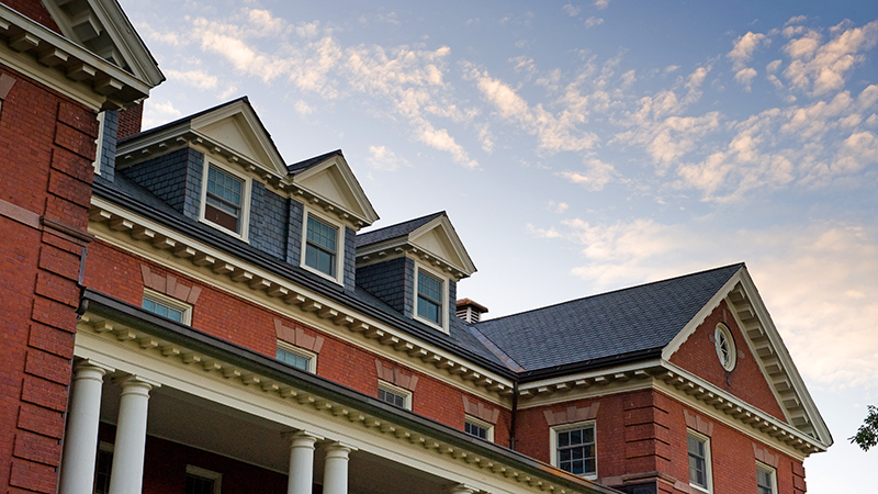 Looking up at the exterior gables of a college building