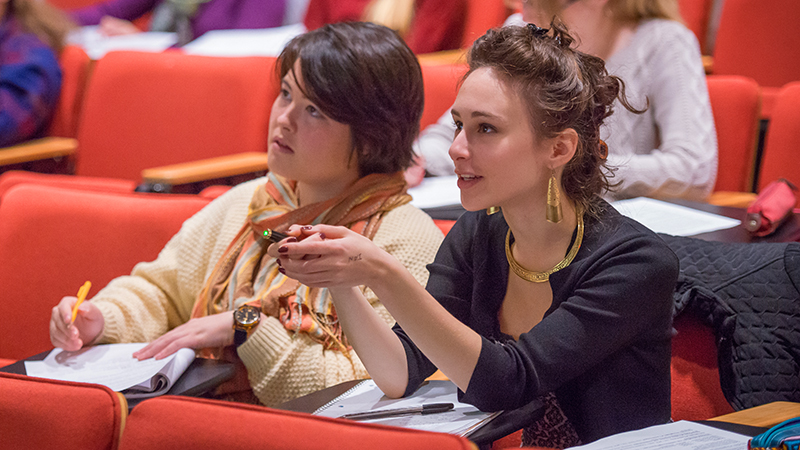 Two students in an auditorium classroom