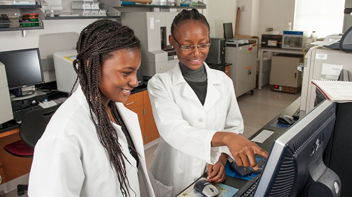 Two Ada Comstock Scholars in a science lab