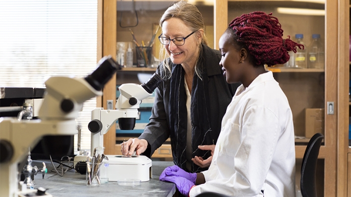 Mary Harrington with Grace Irungu '20 at microscope