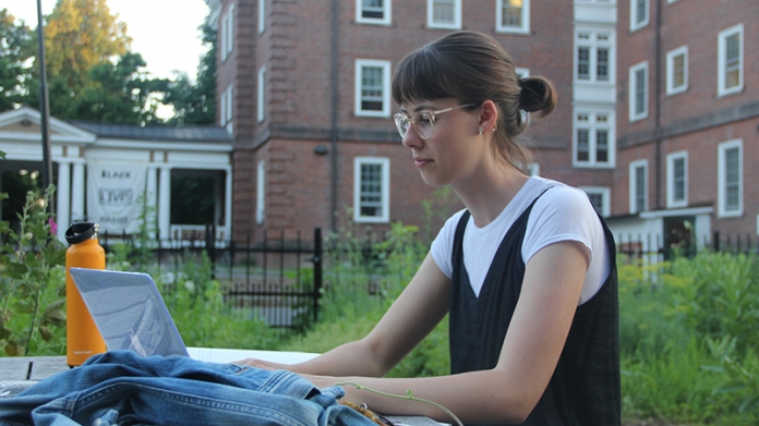 Image of Rachel Pietrow working on a laptop outside