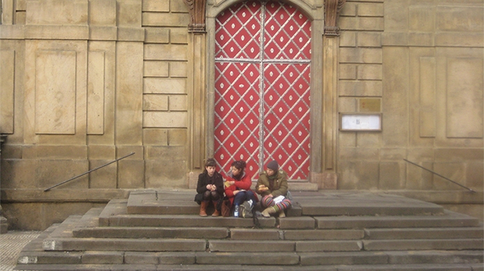 Photo of students sitting on a step in the Czech Republic