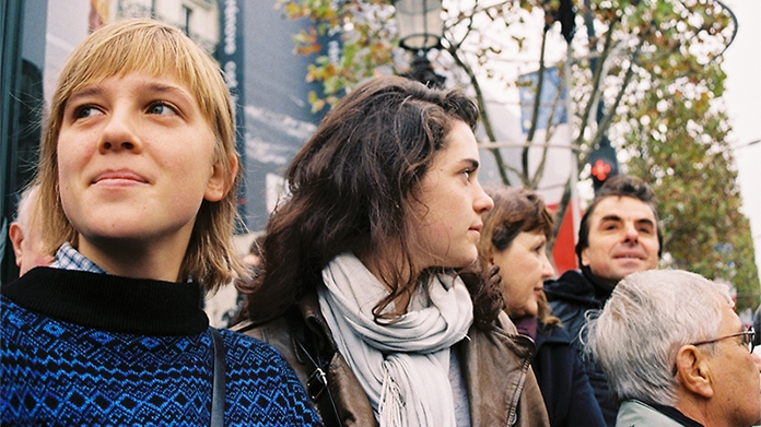 Photo of students abroad watching a protest in Paris