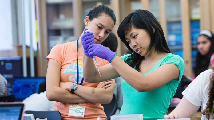 Two high school students looking at a syrninge at the Summer Science & Engineering Program at Smith