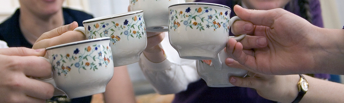 Students toasting with teacups at afternoon tea