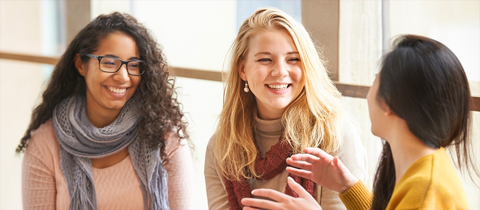 Three students sitting together and talking