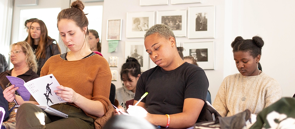 A group of students studying poetry