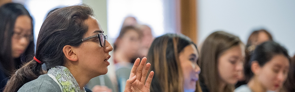 A student gesturing in a class