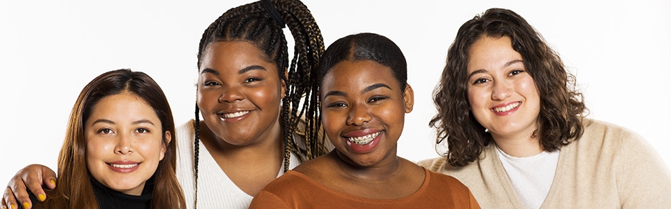 Portrait of four students on a white background