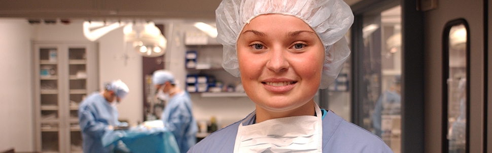 Student in hospital scrubs in an operating room