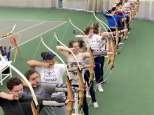 Row of students with drawn bows