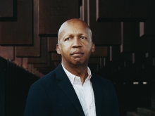 Bryan Stevenson in front of the National Memorial for Peace and Justice