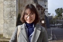 Chloe Hou in front of a stone building