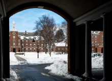 winter courtyard and blue sky seen through an archway