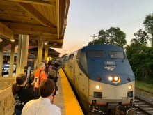 Amtrak train pulling into outdoor station