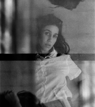 Black and white photo: Garret Bradley looking at the camera through a gauzy film