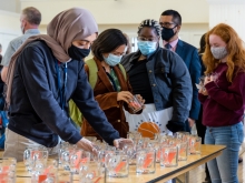 Staff and students picking up glass mugs