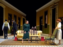 Four actors on stage in a production of A Doll's House