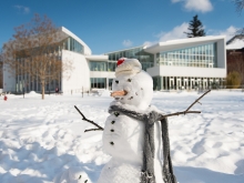 A snowman built in front of the campus center