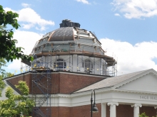 Construction crews and scaffolding on the Sage Hall dome