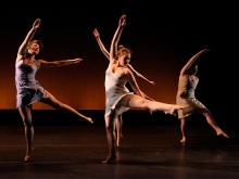 Four dancers in performance on stage