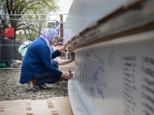 students signing a beam