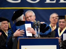 Tom Riddell receives the honored professor award from President Christ