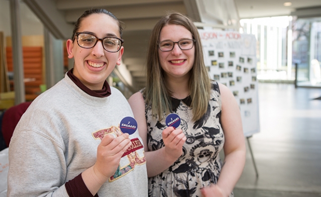 Two students sporting "I Engaged" buttons at the Wheel of Engagement event at the Campus Center