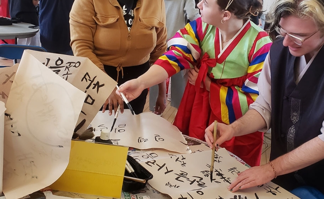 Participants try traditional Korean brush calligraphy.