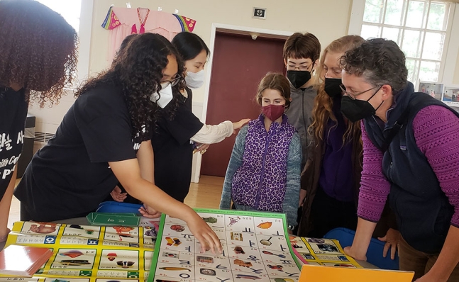 Participants teach guests the Korean alphabet.