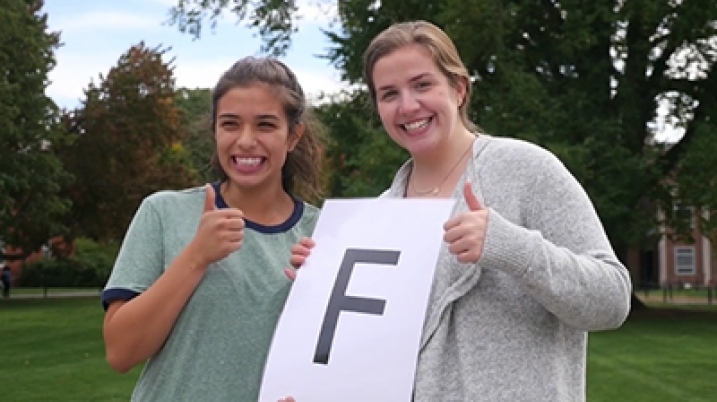 Smith students give thumbs up holding a piece of paper with big "F"